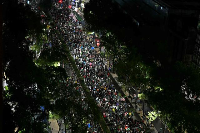 This aerial view shows Mexican fans celebrating on Reforma Avenue after their team won the 2026 World Cup football match against South Korea, in Mexico City on June 18, 2026. (Photo by YURI CORTEZ / AFP)