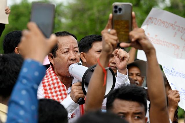 Rong Chhun (centre R), an advisor of the Nation Power Party, marches with supporters towards the Supreme Court in Phnom Penh on June 19, 2026. Cambodia's top court on June 19 suspended a prison sentence handed to opposition politician Rong Chhun but upheld a ban on him running for office, his lawyer said, to the dismay of supporters. (Photo by TANG CHHIN Sothy / AFP)