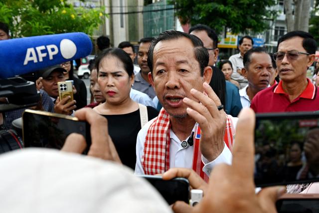 Rong Chhun (C), an advisor of the Nation Power Party, speaks to the media near the Supreme Court in Phnom Penh on June 19, 2026. Cambodia's top court on June 19 suspended a prison sentence handed to opposition politician Rong Chhun but upheld a ban on him running for office, his lawyer said, to the dismay of supporters. (Photo by TANG CHHIN Sothy / AFP)