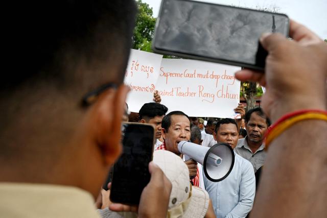 Rong Chhun (C), an advisor of the Nation Power Party, speaks to the media outside the Supreme Court in Phnom Penh on June 19, 2026. Cambodia's top court on June 19 suspended a prison sentence handed to opposition politician Rong Chhun but upheld a ban on him running for office, his lawyer said, to the dismay of supporters. (Photo by TANG CHHIN Sothy / AFP)