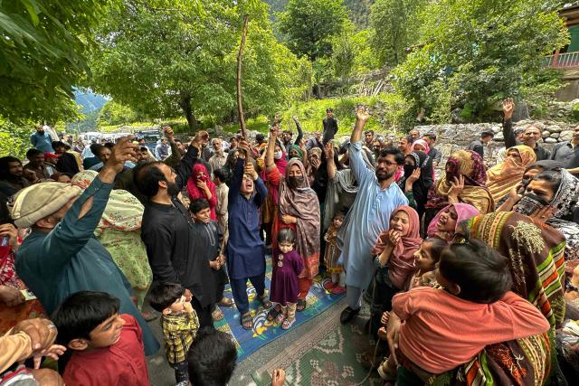 Supporters of the Joint Awami Action Committee (JAAC) shout slogans as they block a road during a weeks-long protest in Neelum Valley, in Pakistan-administered Kashmir, on June 18, 2026, following the group's ban under anti-terrorism laws by local authorities. A nearly two-week standoff between protesters and police in Pakistan-administered Kashmir has left residents grappling with food shortages, while the death toll from clashes rose to 22, according to an AFP tally on June 17. Supporters of the Joint Awami Action Committee (JAAC), an anti-government movement demanding economic and governance reforms, have pressed ahead with protests despite the group being banned this month under anti-terrorism laws. (Photo by AFP)