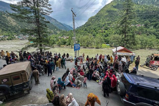 Supporters of the Joint Awami Action Committee (JAAC) gather on a blocked road during a weeks-long protest in Neelum Valley, in Pakistan-administered Kashmir, on June 18, 2026, following the group's ban under anti-terrorism laws by local authorities. A nearly two-week standoff between protesters and police in Pakistan-administered Kashmir has left residents grappling with food shortages, while the death toll from clashes rose to 22, according to an AFP tally on June 17. Supporters of the Joint Awami Action Committee (JAAC), an anti-government movement demanding economic and governance reforms, have pressed ahead with protests despite the group being banned this month under anti-terrorism laws. (Photo by AFP)