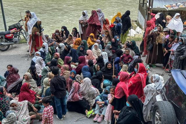 Supporters of the Joint Awami Action Committee (JAAC) gather on a blocked road during a weeks-long protest in Neelum Valley, in Pakistan-administered Kashmir, on June 18, 2026, following the group's ban under anti-terrorism laws by local authorities. A nearly two-week standoff between protesters and police in Pakistan-administered Kashmir has left residents grappling with food shortages, while the death toll from clashes rose to 22, according to an AFP tally on June 17. Supporters of the Joint Awami Action Committee (JAAC), an anti-government movement demanding economic and governance reforms, have pressed ahead with protests despite the group being banned this month under anti-terrorism laws. (Photo by AFP)