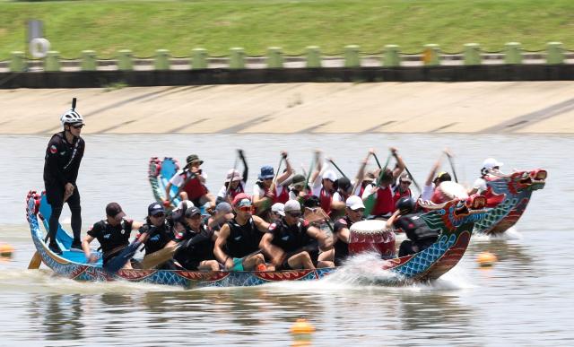 Rowers participate in a dragon boat race to celebrate the Dragon Boat Festival in Taipei on June 19, 2026 (Photo by I-Hwa Cheng / AFP)