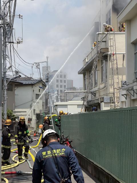 Firefighters from the Tokyo Fire Department carry out firefighting operations at Takinogawa Dai-san Elementary School, where the fire broke out in Tokyo on June 19, 2026. A fire broke out at an elementary school in Tokyo on June 19, injuring at least one person, but all children and staff were evacuated safely, Japanese media reports said. (Photo by JIJI PRESS / AFP) / Japan OUT