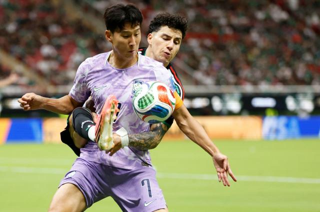 Mexico's defender #02 Jorge Sanchez and South Korea's forward #07 Son Heung-min fight for the ball during the 2026 World Cup Group A football match between Mexico and South Korea at the Guadalajara Stadium in Zapopan on June 18, 2026.  (Photo by Ulises RUIZ / AFP)
