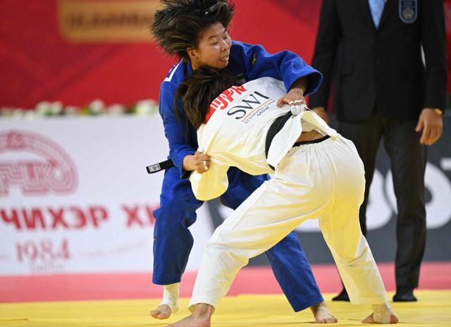 Uta Abe of Japan (white) competes with Khorloodoi Bishrelt of UAE (blue) during the semifinal women under 52kg at the Judo Ulaanbaatar Grand Slam 2026 in Ulaanbaatar, Mongolia on June 19, 2026. (Photo by ADEK BERRY / AFP)