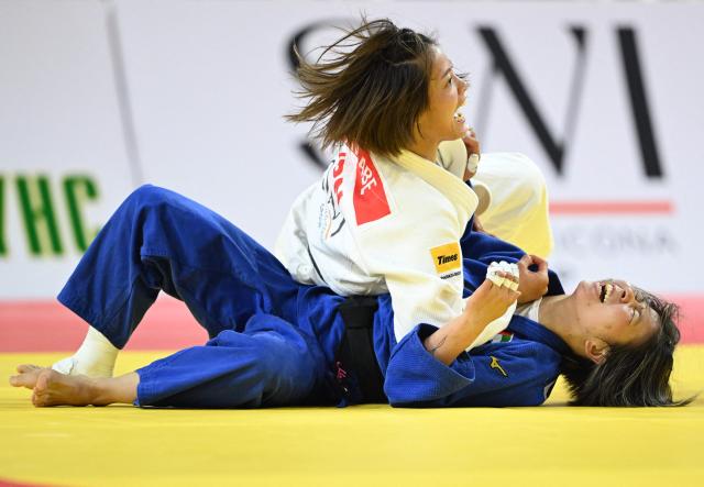 Uta Abe of Japan (white) reacts after winning against Khorloodoi Bishrelt of UAE (blue) during the semifinal women under 52kg at the Judo Ulaanbaatar Grand Slam 2026 in Ulaanbaatar, Mongolia on June 19, 2026. (Photo by ADEK BERRY / AFP)