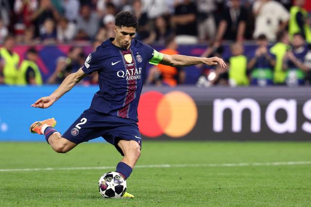 (FILES) Paris Saint-Germain's Moroccan defender #02 Achraf Hakimi takes a penalty during the penalty shootout during the UEFA Champions League final football match between Paris Saint-Germain (PSG) and Arsenal FC at the Puskas Arena in Budapest on May 30, 2026. A French appeals court on June 19, 2026 confirmed Moroccan football star Achraf Hakimi will stand trial charged with raping a young woman. In February 2023, a woman then aged 24 told police in the Val-De-Marne region southeast of Paris that Hakimi had raped her. The Paris Saint-Germain player and captain of the Moroccan national team, whose side are playing their second World Cup match on June 19 against Scotland, has consistently denied the allegations. (Photo by FRANCK FIFE / AFP)