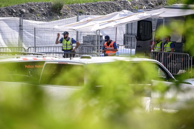 Police officers secure the access to the Burgenstock luxury hotel complex above Lake Lucerne, where talks following up on a deal to end the Middle East conflict were scheduled to begin, on June 19, 2026. Switzerland announced on June 19, 2026 that planned talks following up on the deal to end the Middle East war had been postponed, hours after US Vice President JD Vance's departure for the Alpine country was cancelled. (Photo by Fabrice COFFRINI / AFP)