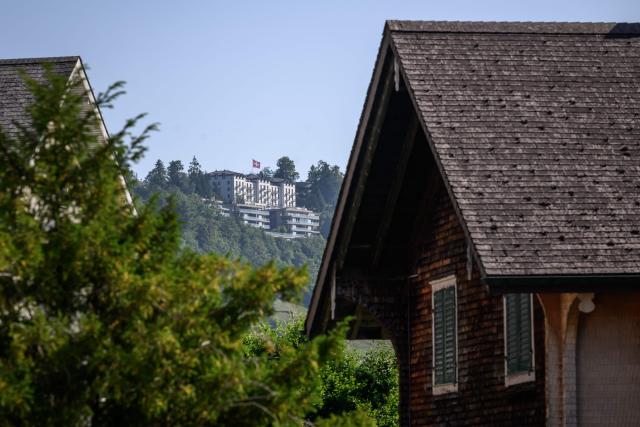 This photograph shows a part of the Burgenstock luxury hotel complex (C) above Lake Lucerne, where talks following up on a deal to end the Middle East conflict were scheduled to begin, on June 19, 2026. Switzerland announced on June 19, 2026 that planned talks following up on the deal to end the Middle East war had been postponed, hours after US Vice President JD Vance's departure for the Alpine country was cancelled. (Photo by Fabrice COFFRINI / AFP)