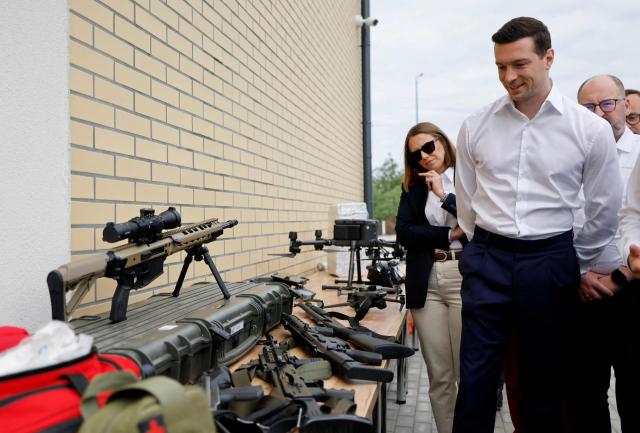 French far-right Rassemblement National (RN) party's President, member of the European Parliament and president of the Patriots for Europe (PfE) group Jordan Bardella (L) and MEP Anna Brylka of the Patriots for Europe Group (L) inspect equipment of the border guards during a visit to Poland's border with Belarus near Kuznica,eastern Poland on June 19, 2026. Jordan Bardella is on a two-day visit to Poland meeting with leaders of Polands far right and touring the eastern border, marking the latest stop on his overseas tour aimed at strengthening his European alliances just a few months before the French presidential election. (Photo by Wojtek RADWANSKI / AFP)