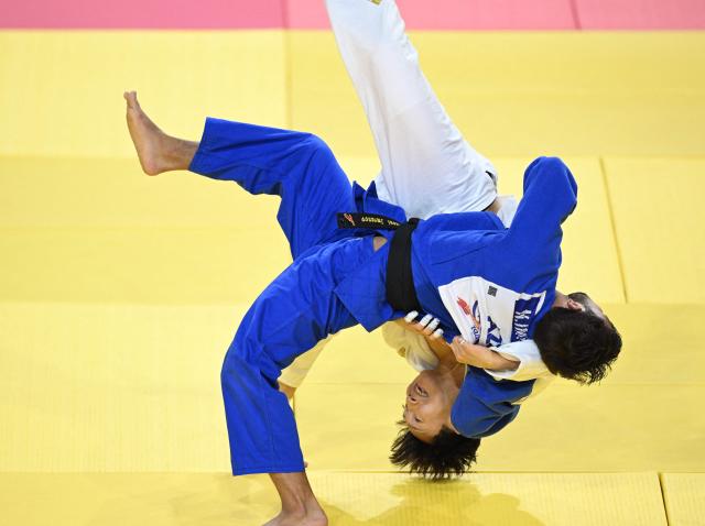 Kim  Chann-yeong of South Korea (white) competes with Nizami Imranov of Azerbaijan (blue) during their quarterfinal Men under 66kg at the Judo Ulaanbaatar Grand Slam 2026 in Ulaanbaatar, Mongolia on June 19, 2026. (Photo by ADEK BERRY / AFP)