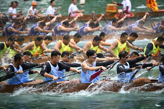 Competitors take part in dragon boat races held to celebrate the Tuen Ng festival in the Aberdeen typhoon shelter in Hong Kong on June 19, 2026. (Photo by Peter PARKS / AFP)