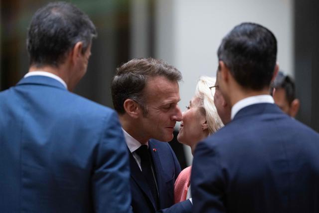 France's President Emmanuel Macron (centre L) welcomes European Commission President Ursula von der Leyen before the start of a round table meeting during the EU Summit at the EU headquarters in Brussels, on June 19, 2026. (Photo by JOHN THYS / AFP)
