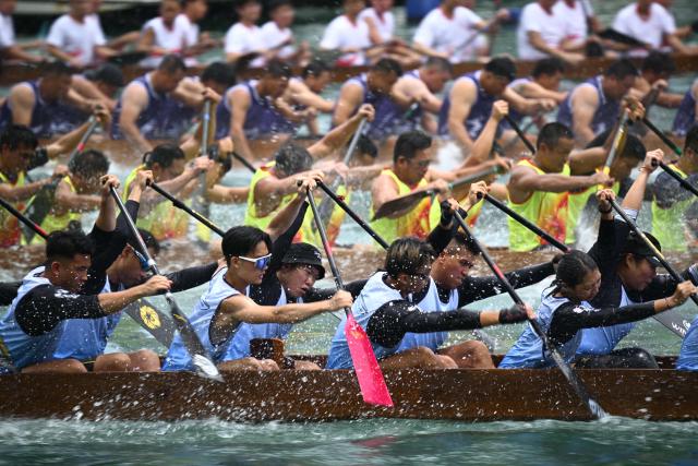 Competitors take part in dragon boat races held to celebrate the Tuen Ng festival in the Aberdeen typhoon shelter in Hong Kong on June 19, 2026. (Photo by Peter PARKS / AFP)