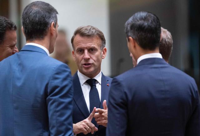 France's President Emmanuel Macron (C) speaks with Spain's Prime Minister Pedro Sanchez (L) and Netherlands'  Prime Minister Rob Jetten (R) before the start of a round table meeting during the EU Summit at the EU headquarters in Brussels, on June 19, 2026. (Photo by JOHN THYS / AFP)