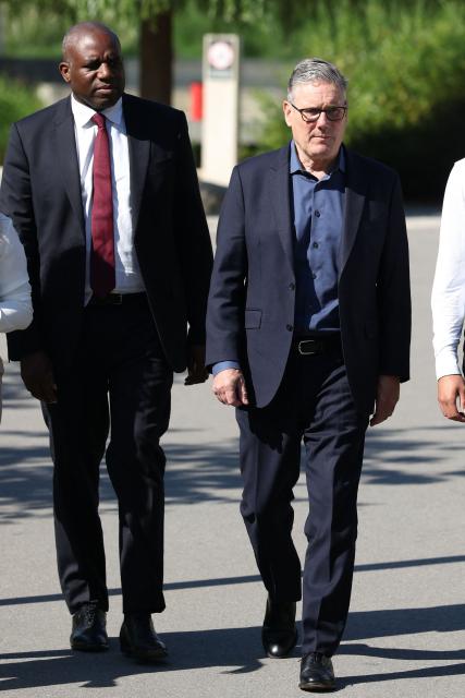 Britain's Prime Minister Keir Starmer (R) arrives with Britain's Justice Secretary and deputy Prime Minister David Lammy (L) for a visit to a housing development in north-west London on June 19, 2026, with a formal challenge to his leadership likely to be triggered in the near future. Veteran UK Labour politician Andy Burnham emphatically won a crunch by-election on Friday, securing a parliamentary seat and clearing the way for a widely expected leadership challenge against beleaguered Prime Minister Keir Starmer. (Photo by Peter MACDIARMID / POOL / AFP)