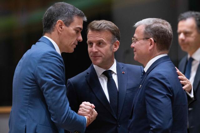 France's President Emmanuel Macron (C) speaks with Spain's Prime Minister Pedro Sanchez (L) and Finland's Prime Minister Petteri Orpo (R) before the start of a round table meeting during the EU Summit at the EU headquarters in Brussels, on June 19, 2026. (Photo by JOHN THYS / AFP)