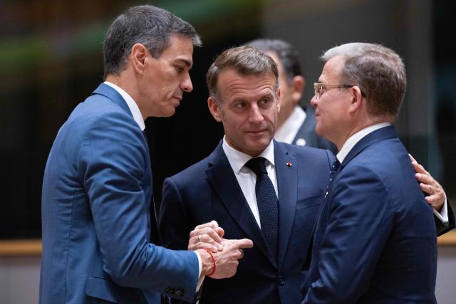 France's President Emmanuel Macron (C) speaks with Spain's Prime Minister Pedro Sanchez (L) and Finland's Prime Minister Petteri Orpo (R) before the start of a round table meeting during the EU Summit at the EU headquarters in Brussels, on June 19, 2026. (Photo by JOHN THYS / AFP)