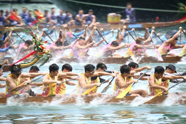Competitors take part in dragon boat races held to celebrate the Tuen Ng festival in the Aberdeen typhoon shelter in Hong Kong on June 19, 2026. (Photo by Peter PARKS / AFP)