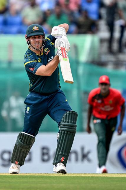 Australia's captain Mitchell Marsh watches the ball after playing a shot during the second Twenty20 (T20) international cricket match between Bangladesh and Australia at the Bir Sreshtho Flight Lieutenant Matiur Rahman Stadium in Chattogram on June 19, 2026. (Photo by AFP)