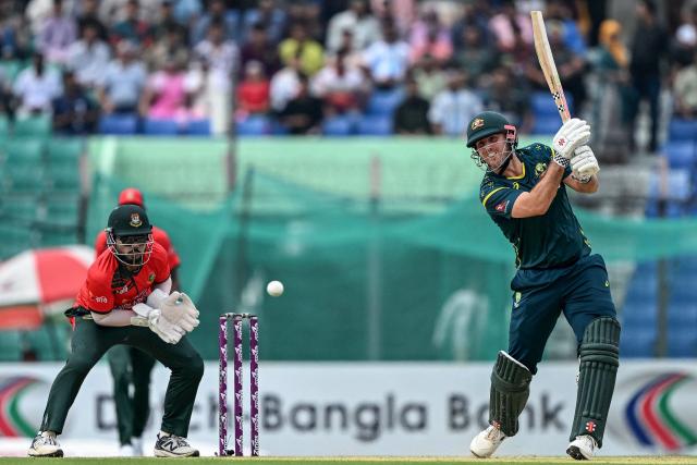 Australia's captain Mitchell Marsh (R) plays a shot during the second Twenty20 (T20) international cricket match between Bangladesh and Australia at the Bir Sreshtho Flight Lieutenant Matiur Rahman Stadium in Chattogram on June 19, 2026. (Photo by AFP)