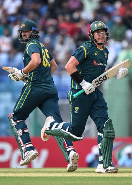 Australia's Tim David (L) and Matt Renshaw run between the wickets during the second Twenty20 (T20) international cricket match between Bangladesh and Australia at the Bir Sreshtho Flight Lieutenant Matiur Rahman Stadium in Chattogram on June 19, 2026. (Photo by AFP)
