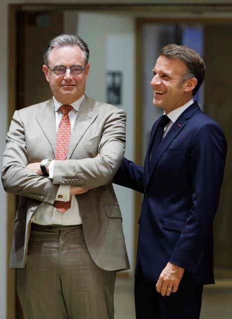 France's President Emmanuel Macron (R) and Belgium's Prime Minister Bart De Wever speak prior to a round table meeting during the EU Summit at the EU headquarters in Brussels, on June 19, 2026. (Photo by BENOIT DOPPAGNE / BELGA / AFP) / Belgium OUT