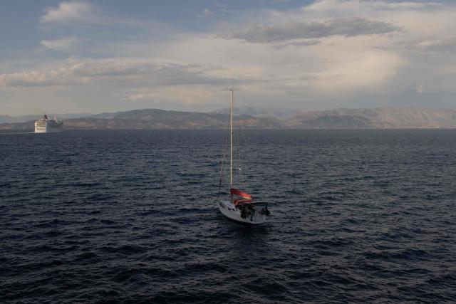 A boat sails on the Mediterranean sea off coast of the Greek island of Corfu on June 17, 2026. (Photo by Roman PILIPEY / AFP)