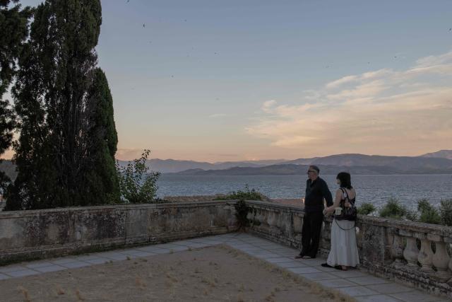 People look at the Mediterranean sea from a view point as they visit the old town of Corfu at sunset, on the Greek island of Corfu on June 17, 2026. (Photo by Roman PILIPEY / AFP)