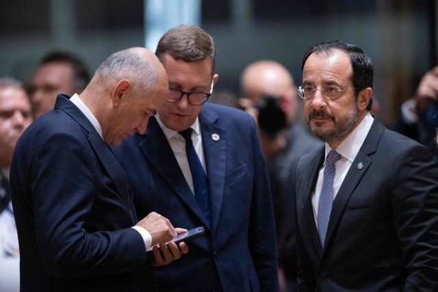 (From L) Slovenia's Prime Minister Janez Jansa, Estonia's Prime Minister Kristen Michal and Cyprus' President Nikos Christodoulides speak prior to a round table meeting during the EU Summit at the EU headquarters in Brussels, on June 19, 2026. (Photo by JOHN THYS / AFP)