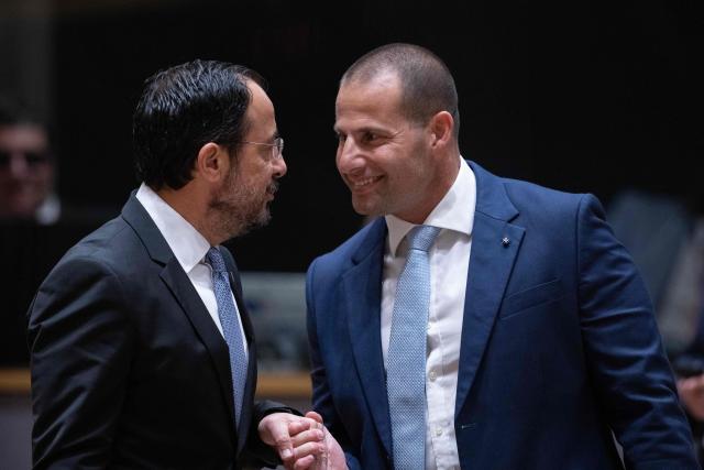 Malta's Prime Minister Robert Abela (R) and Cyprus' President Nikos Christodoulides  speak before the start of a round table meeting during the EU Summit at the EU headquarters in Brussels, on June 19, 2026. (Photo by JOHN THYS / AFP)