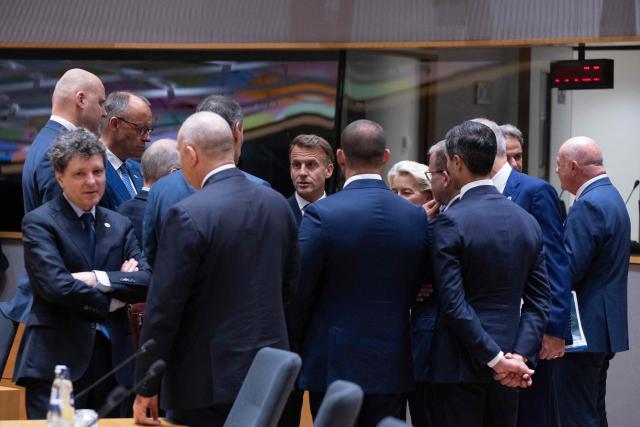 France's President Emmanuel Macron (C) speaks with EU leader prior to a round table meeting during the EU Summit at the EU headquarters in Brussels, on June 19, 2026. (Photo by JOHN THYS / AFP)