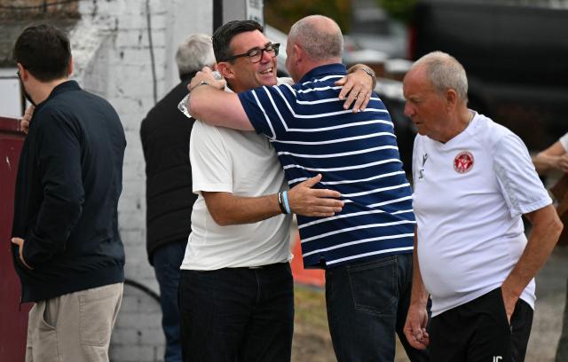 New Labour Party MP for Makerfield, Andy Burnham (centre L) is greeted as he arrives to speaks to members of the media, the morning after his by-election victory, at Ashton Town FC, in Ashton in Makerfield, north-west England on June 19, 2026. Veteran UK Labour politician Andy Burnham emphatically won a crunch by-election on Friday, securing a parliamentary seat and clearing the way for a widely expected leadership challenge against beleaguered Prime Minister Keir Starmer. (Photo by Oli SCARFF / AFP)