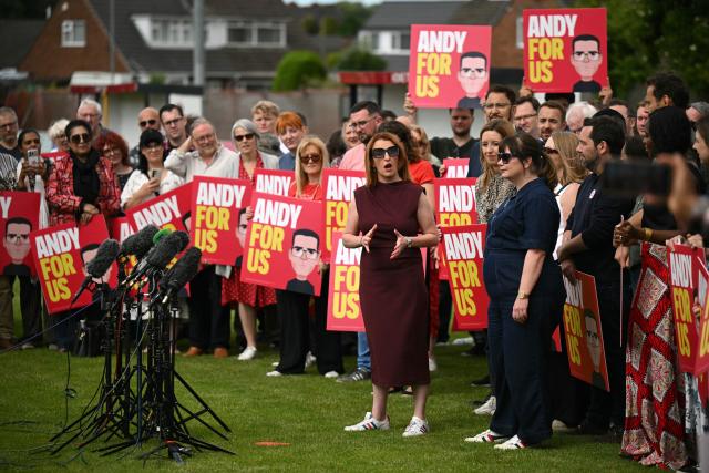 Louise Haigh (C) speaks to introduce new Labour Party MP for Makerfield, Andy Burnham, the morning after his by-election victory, at Ashton Town FC, in Ashton in Makerfield, north-west England on June 19, 2026. Veteran UK Labour politician Andy Burnham emphatically won a crunch by-election on Friday, securing a parliamentary seat and clearing the way for a widely expected leadership challenge against beleaguered Prime Minister Keir Starmer. (Photo by Oli SCARFF / AFP)