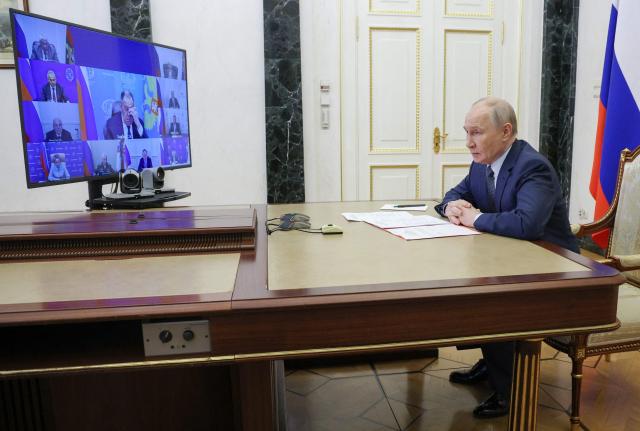 In this pool photograph distributed by the Russian state agency Sputnik, Russia's President Vladimir Putin chairs a Security Council meeting via videolink in Moscow on June 19, 2026. (Photo by Vyacheslav PROKOFYEV / POOL / AFP)