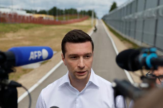 French far-right Rassemblement National (RN) party's President, member of the European Parliament and president of the Patriots for Europe (PfE) group Jordan Bardella talks to journalists during a visit to Poland's border with Belarus near Kuznica, eastern Poland on June 19, 2026. Jordan Bardella is on a two day visit to poland meeting with leaders of Polands far right and touring the eastern border, marking the latest stop on his overseas tour aimed at strengthening his European alliances just a few months before the French presidential election. (Photo by Wojtek RADWANSKI / AFP)