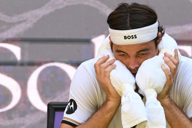 USA's Taylor Fritz reacts during a break as he plays against USA's Ben Shelton during their men's singles quarter-final match of the Halle Open ATP tennis tournament in Halle, western Germany, on June 19, 2026. (Photo by CARMEN JASPERSEN / AFP)