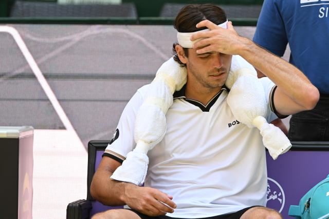 USA's Taylor Fritz reacts during a break as he plays against USA's Ben Shelton during their men's singles quarter-final match of the Halle Open ATP tennis tournament in Halle, western Germany, on June 19, 2026. (Photo by CARMEN JASPERSEN / AFP)
