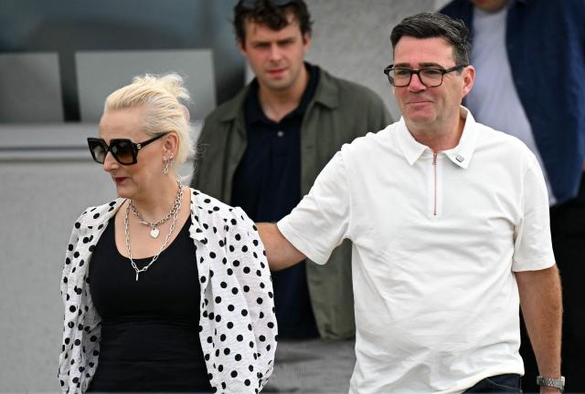 New Labour Party MP for Makerfield, Andy Burnham arrives with his wife Marie-France van Heel, to speak to to supporters and members of the media, the morning after his by-election victory, at Ashton Town FC, in Ashton in Makerfield, north-west England on June 19, 2026. Veteran UK Labour politician Andy Burnham emphatically won a crunch by-election on Friday, securing a parliamentary seat and clearing the way for a widely expected leadership challenge against beleaguered Prime Minister Keir Starmer. (Photo by Oli SCARFF / AFP)