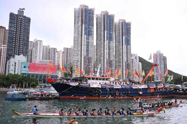 Competitors take part in dragon boat races held to celebrate the Tuen Ng festival in the Aberdeen typhoon shelter in Hong Kong on June 19, 2026. (Photo by Peter PARKS / AFP)