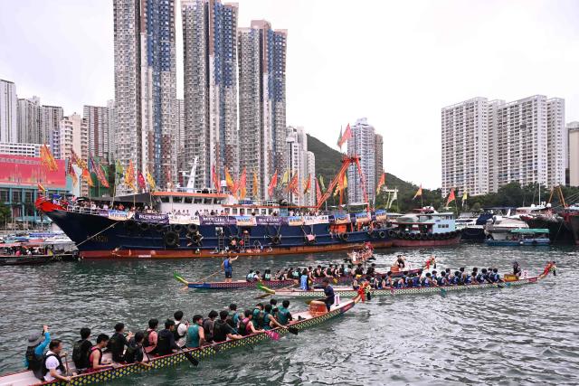 Competitors take part in dragon boat races held to celebrate the Tuen Ng festival in the Aberdeen typhoon shelter in Hong Kong on June 19, 2026. (Photo by Peter PARKS / AFP)
