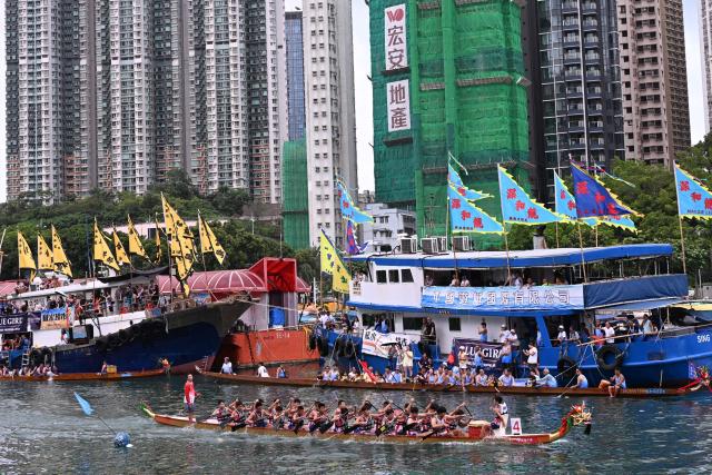 Competitors take part in dragon boat races held to celebrate the Tuen Ng festival in the Aberdeen typhoon shelter in Hong Kong on June 19, 2026. (Photo by Peter PARKS / AFP)