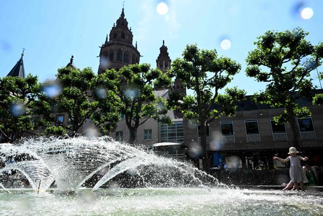A child cools at a fountain in central Mainz, western Germany, on June 19, 2026 with air temperature reaching 33 degrees Celsius. (Photo by Kirill KUDRYAVTSEV / AFP)