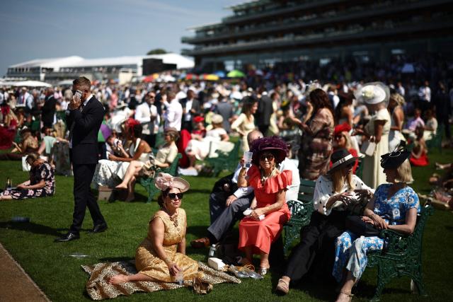Racegoers relax on the fourth day of the Royal Ascot horse racing meeting in Ascot, west of London, on June 19, 2026. (Photo by Henry Nicholls / AFP)
