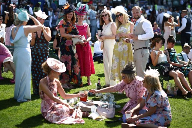 Racegoers pose for a picture on the fourth day of the Royal Ascot horse racing meeting in Ascot, west of London, on June 19, 2026. (Photo by Henry Nicholls / AFP)