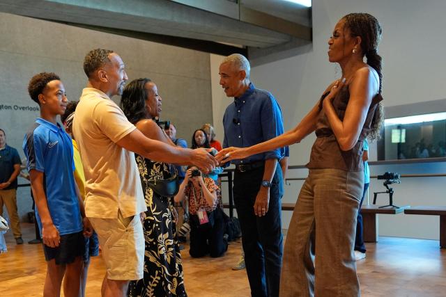 Former US President Barack Obama and former first lady Michelle Obama greet the first group of visitors at the official opening of the Obama Presidential Center in Chicago, Illinois on June 19, 2026. This is the first day the Barack Obama Presidential Center is open to the public. (Photo by Pablo Martinez Monsivais / POOL / AFP)