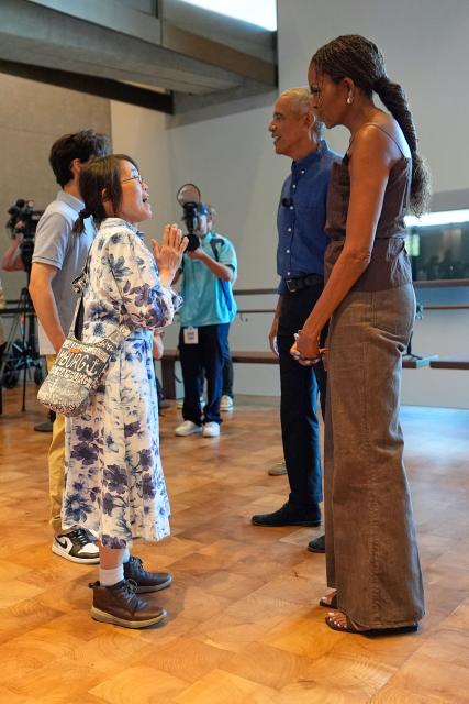 Former US President Barack Obama and former first lady Michelle Obama greet the first group of visitors at the official opening of the Obama Presidential Center in Chicago, Illinois on June 19, 2026. This is the first day the Barack Obama Presidential Center is open to the public. (Photo by Pablo Martinez Monsivais / POOL / AFP)