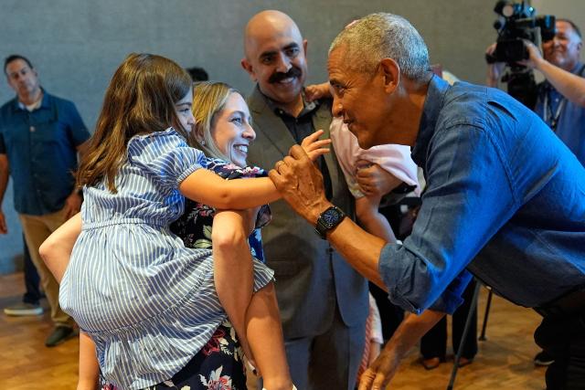 Former US President Barack Obama and former first lady Michelle Obama greet the first group of visitors at the official opening of the Obama Presidential Center in Chicago, Illinois on June 19, 2026. This is the first day the Barack Obama Presidential Center is open to the public. (Photo by Pablo Martinez Monsivais / POOL / AFP)